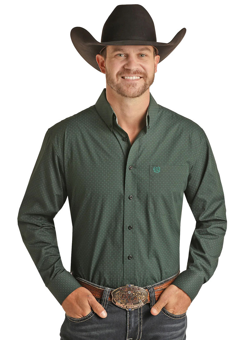 Scruffy man in black cowboy hat, green button shirt, and black jeans