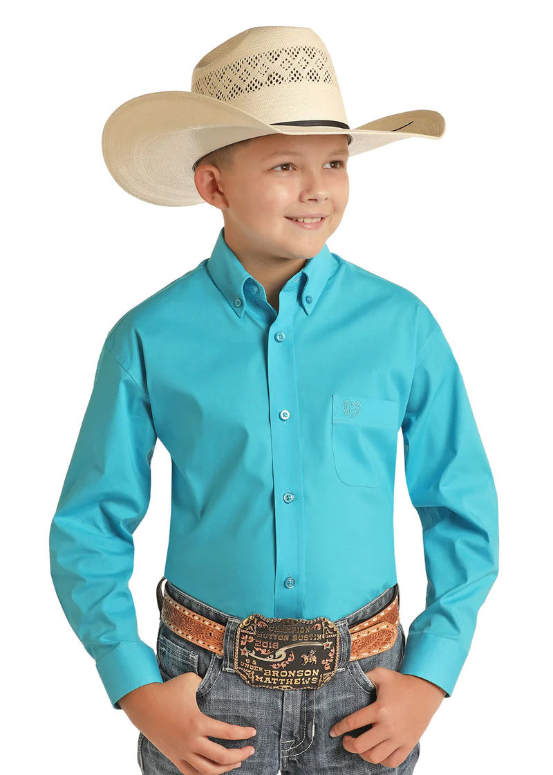 Young boy in light cowboy hat, blue button shirt, and gray jeans